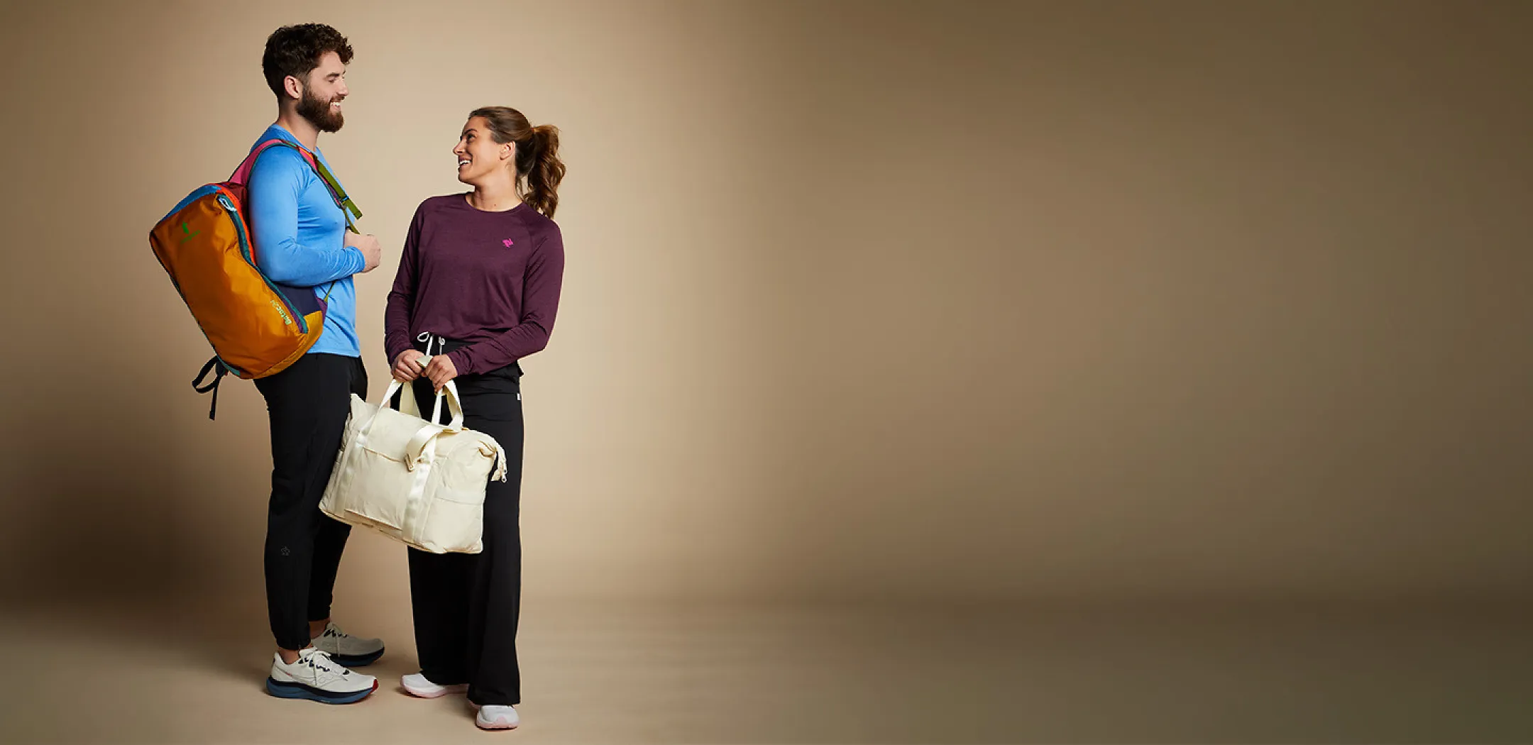 man and woman posing with running clothes and gear